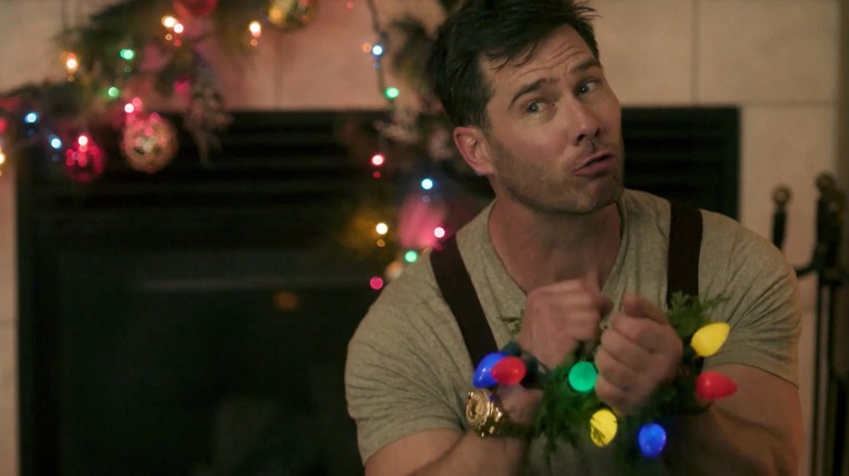 Chris (Luke Macfarlane) tied up in Christmas lights in Catch Me If You Clause