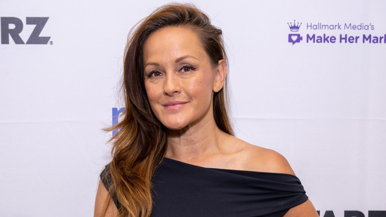 Crystal Lowe wearing a black dress