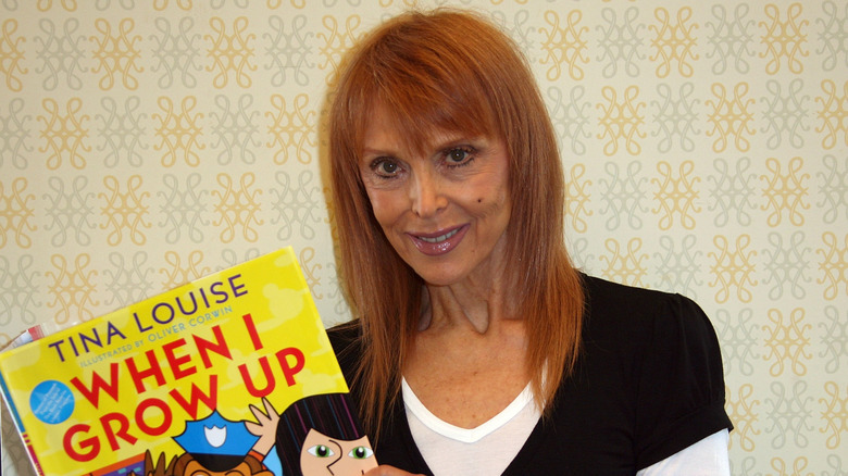Actor Tina Louise smiles holding the children's book she wrote called "When I Grow Up"