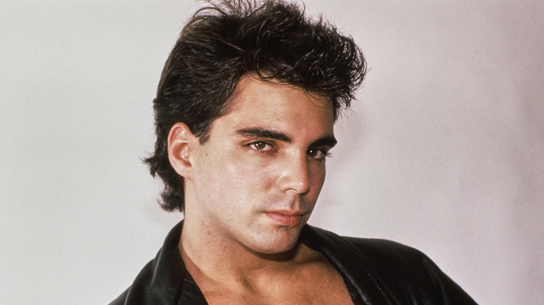 Richard Grieco posing in a leather jacket with no shirt underneath