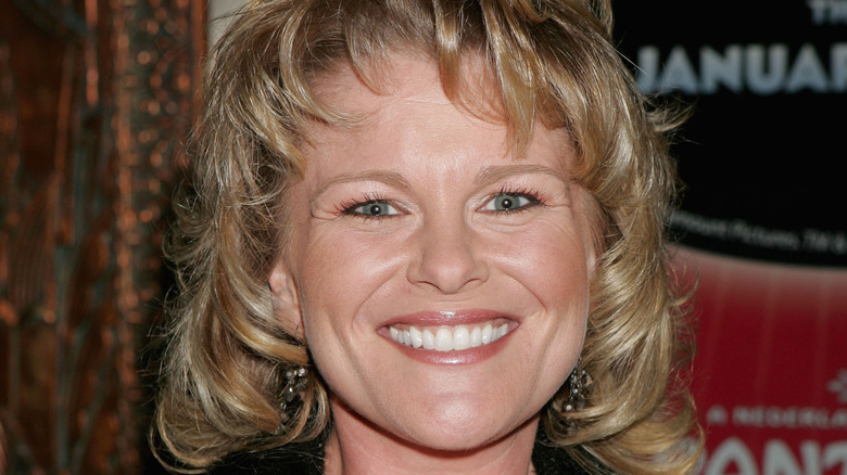 Judi Evans smiles for the camera. 