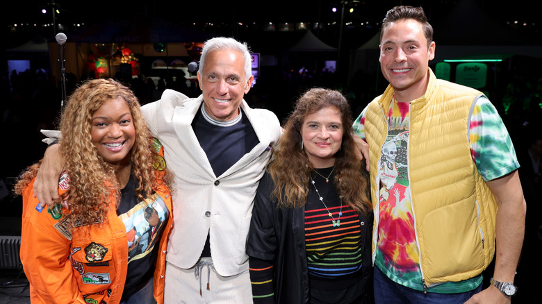 Alex Guarnaschelli  poses with her co-hosts of "The Kitchen" with their arms around each other