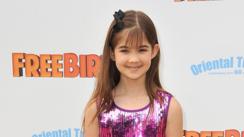 Kaitlyn Maher smiling at the premiere of "Free Birds" in 2013