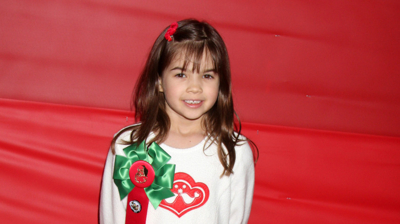 Kaitlyn Maher smiling at the Hollywood Christmas parade in 2010