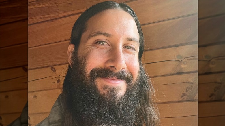 Avi Kaplan smiles while taking a selfie