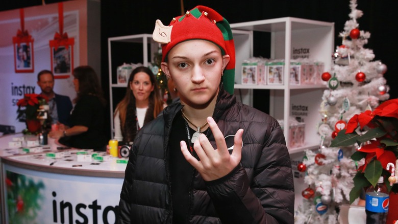 The Backpack Kid in 2018 in front of an Instax stand