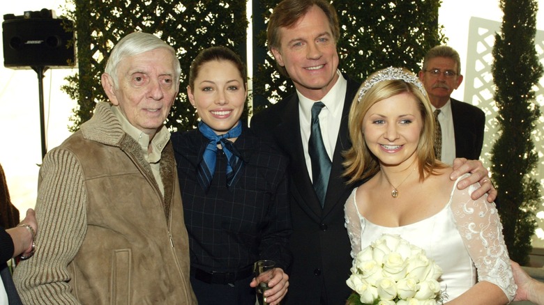 Aaron Spelling, Jessica Biel, and Stephen Collins, who has his arm about Beverley Mitchell in a wedding dress
