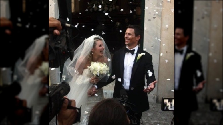 Beverley Mitchell and her husband Michael Cameron on their wedding day, being showered with flower petals