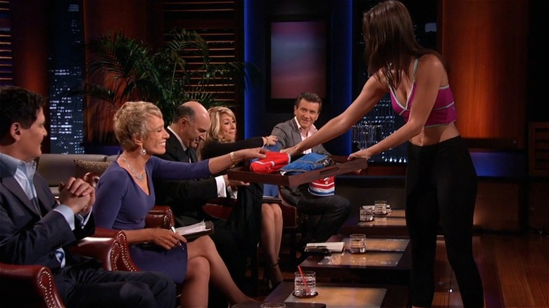 Model hands out Boobypack samples to Shark Tank panel