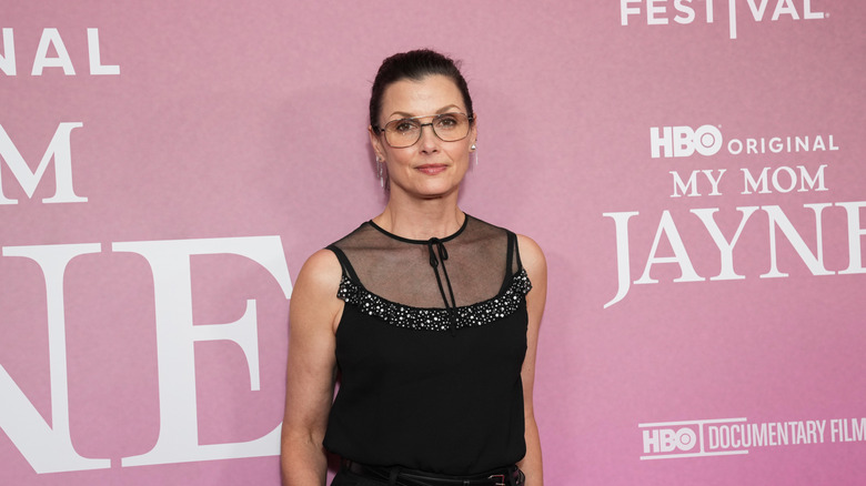 Bridget Moynahan in a black dress and glasses