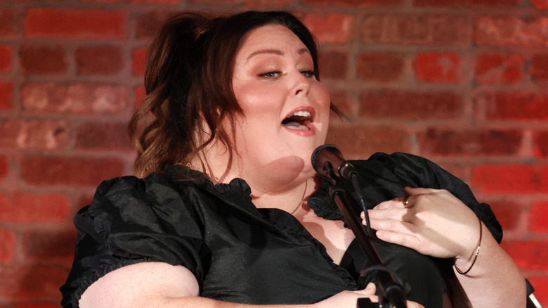 Chrissy Metz singing into a microphone.