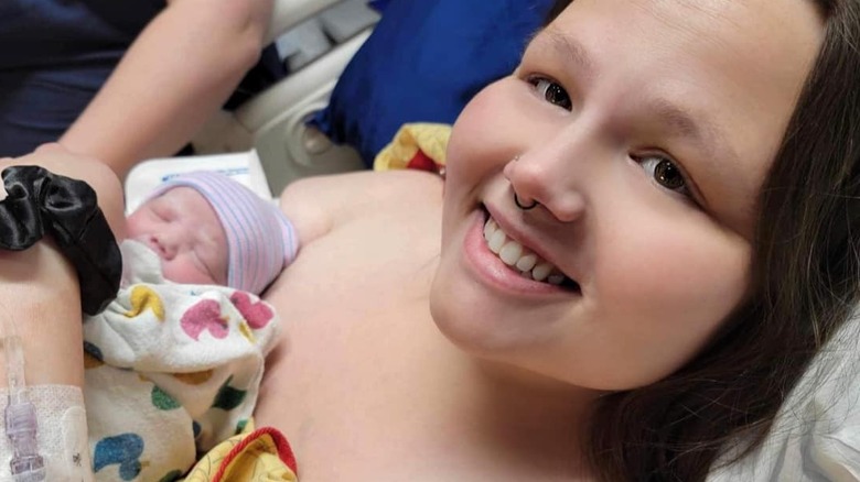 Christina Phillips holds her newborn daughter and smiles.