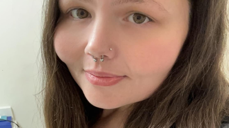Christina Phillips smiles with her lips closed in a close up selfie