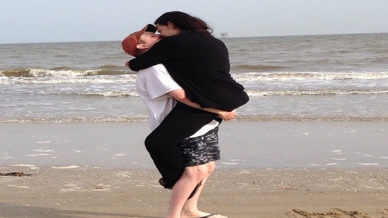 Christina Phillips kisses her new boo in front of the ocean in his arms