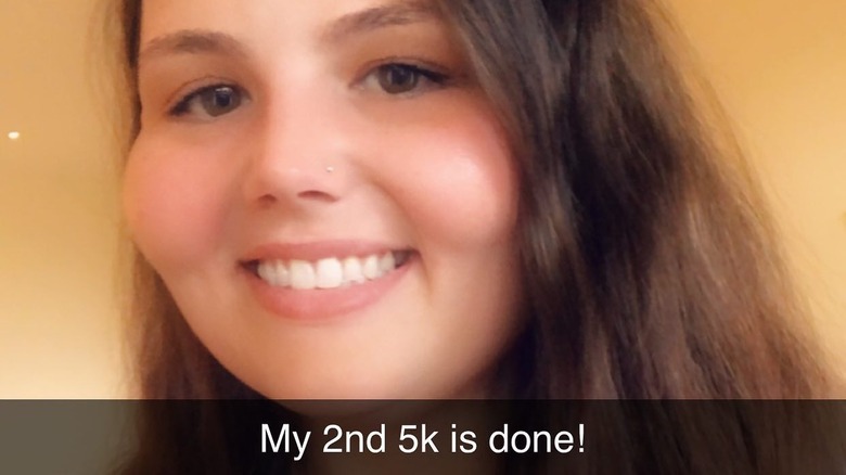 Christina Phillips smiles in a picture overlaid with text saying "My 2nd 5K is done!"