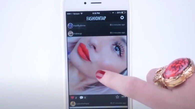 Person scrolling through FashionTap site