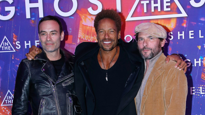 Gary Dourdan puts his arms around fellow actors at the Paris premiere of Paramount's "Ghost in the Shell" in 2017