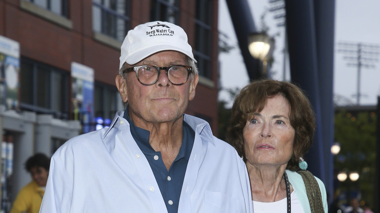 Tom Brokaw wearing white baseball cap