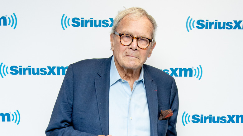 Tom Brokaw posing in front of SiriusXM background