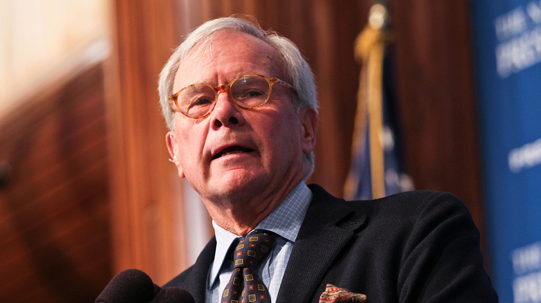 Tom Brokaw speaking at a podium