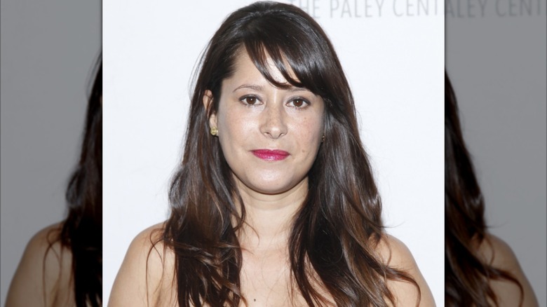Kimberly McCullough smiling while posing at an event