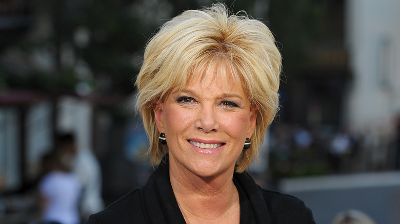 Smiling Joan Lunden with black earrings and blazer