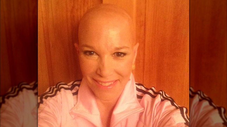 Joan Lunden posing for a selfie, showcasing her bald head amid cancer treatment