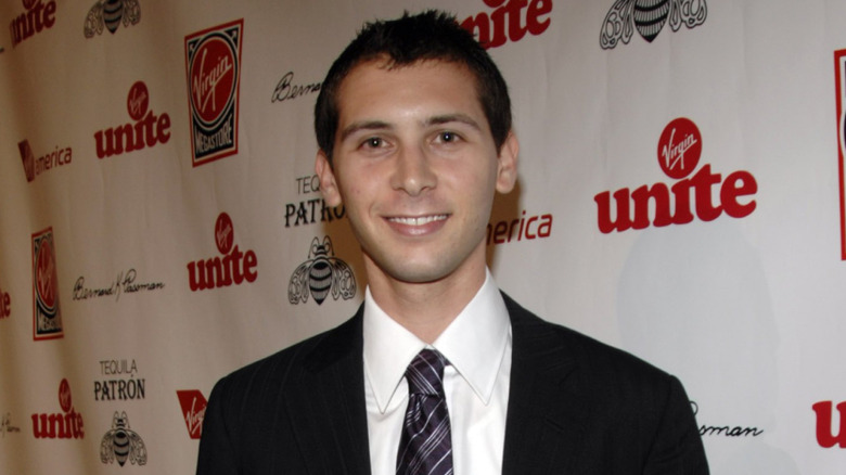 Closeup of Justin Berfield smiling against Virgin Unite step-and-repeat