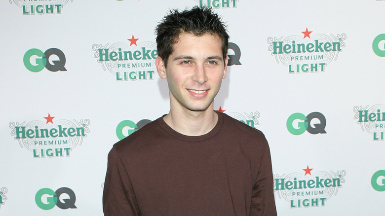 Closeup of Justin Berfield smiling against GQ step-and-repeat