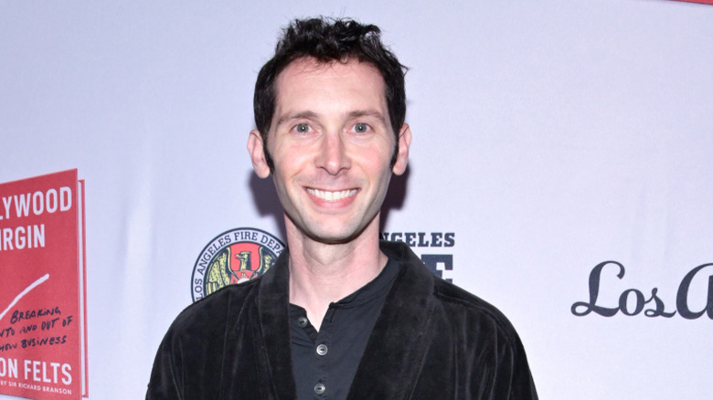 Closeup of Justin Berfield smiling against step-and-repeat