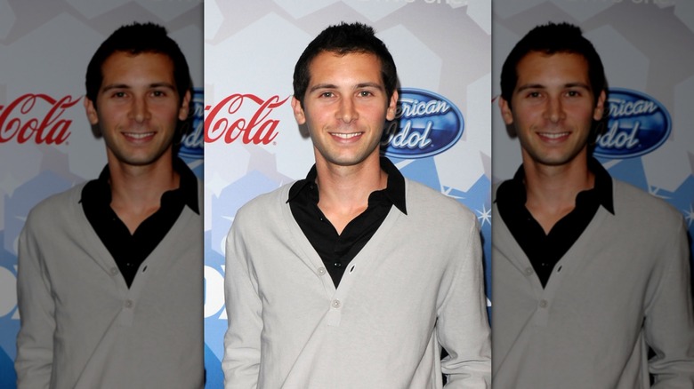 Closeup of Justin Berfield smiling against American Idol step-and-repeat