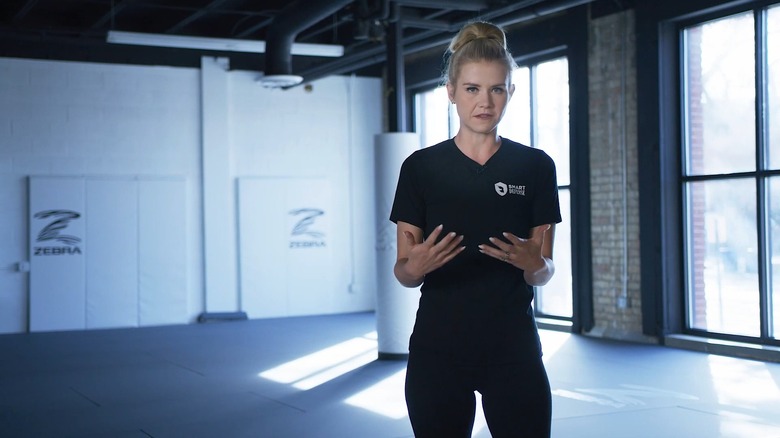 Elizabeth Smart wearing a Smart Defense outfit in a white, well-lit gym