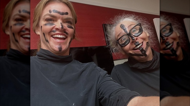 Missi Pyle and Brooke Dillman smiling with black paint on their face