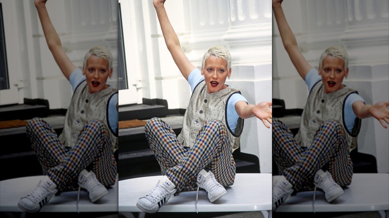 Lori Petty sitting on a desk