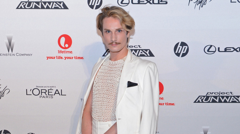 Austin Scarlett posing on a red carpet in 2012.