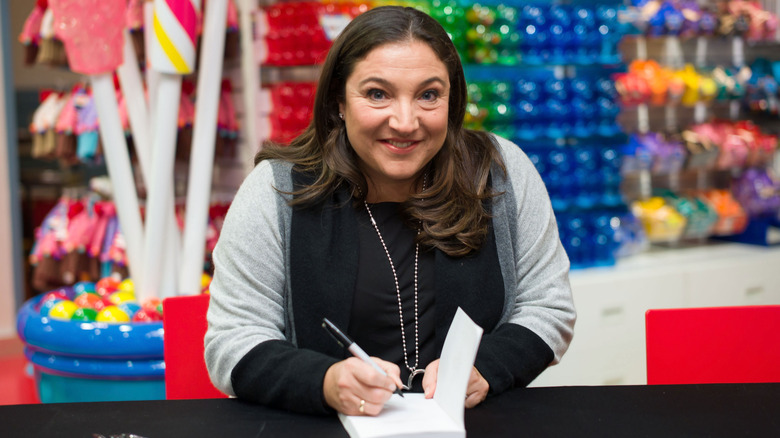 Jo Frost signing a book at a candy store