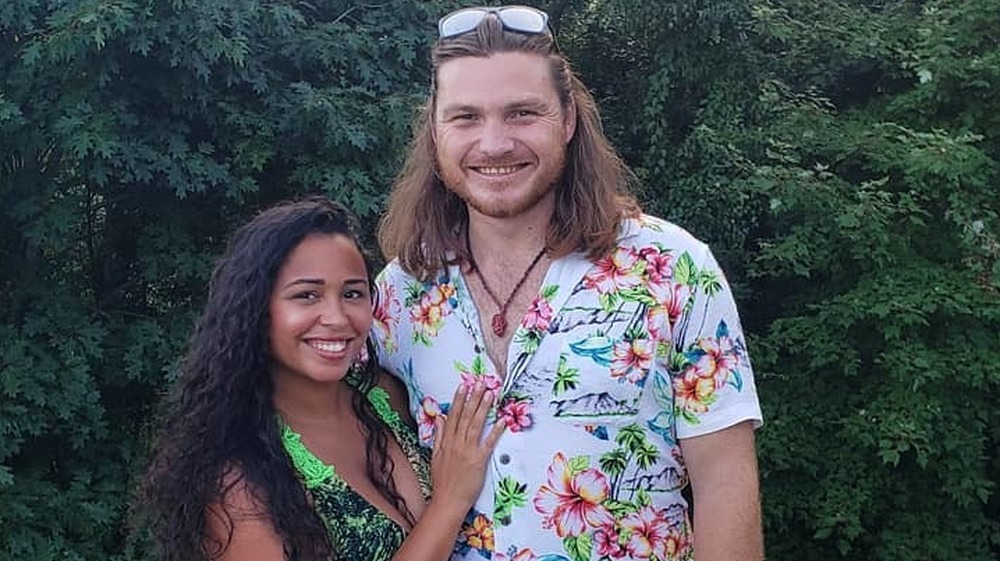 Tania and Syngin pose on holiday together