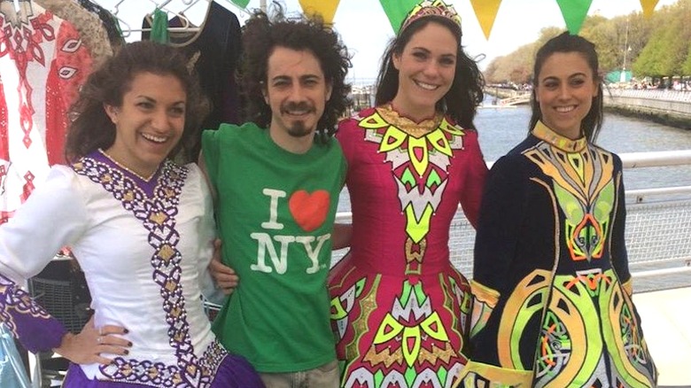 Adam Lamberg, the actor who played Gordo on "Lizzie McGuire," stands between Irish dancers wearing a green shirt