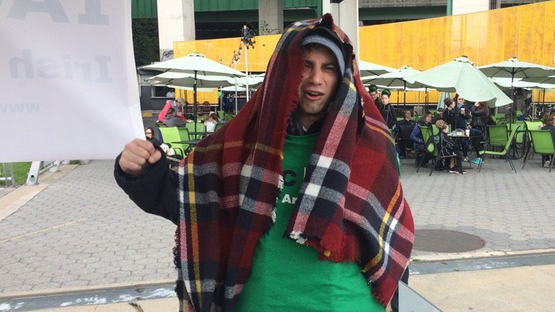 Adam Lamberg wearing a blanket over his head outside of the Irish Arts Center in 2017