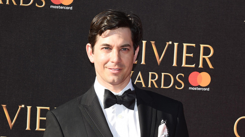Actor Adam Garcia smiles in a tuxedo at the Laurence Olivier awards.