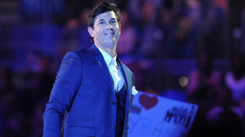 Adam Garcia smiles in a suit on the set of Got to Dance