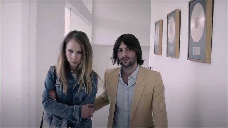 Still of Robert Schwartzman in beige suit in "Lost Transmissions."