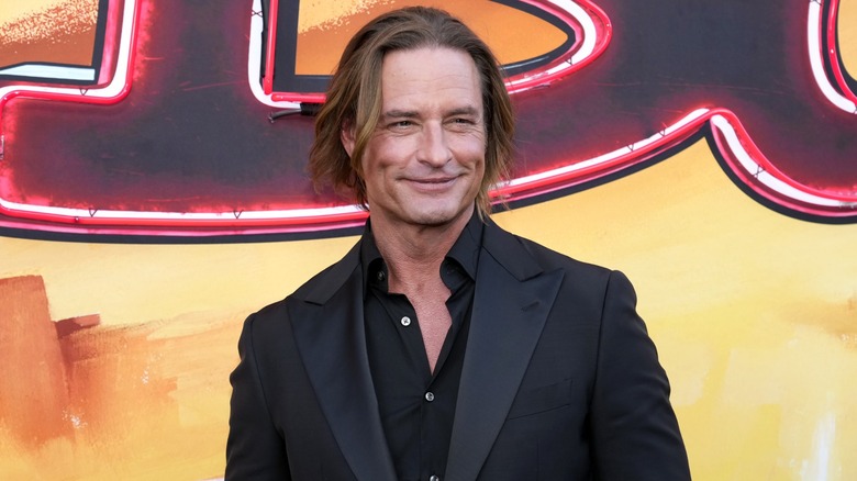 Josh Holloway smiling on the red carpet for the premiere of Duster