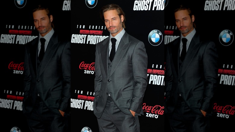 Josh Holloway looking dapper in a gray suit on the red carpet for Mission: Impossible - Ghost Protocol