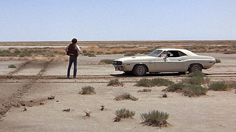 A character near a car in Vanishing Point