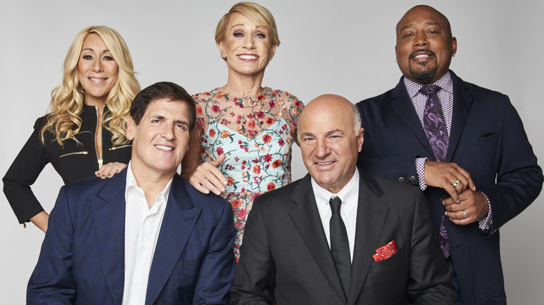 shark tank hosts smiling for photo