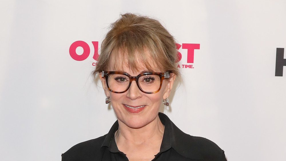 Patricia Richardson smiling with dark rimmed glasses 