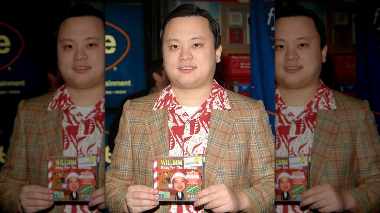 William Hung at FYE holding his Christmas EP Hung for the Holidays