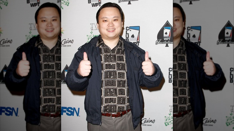 William Hung on a step-and-repeat flashing two thumbs up to the camera