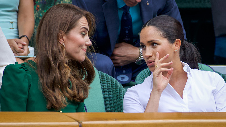 Princess Catherine and Meghan Markle chat at Wimbledon